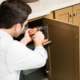 Guy Installing Cabinets